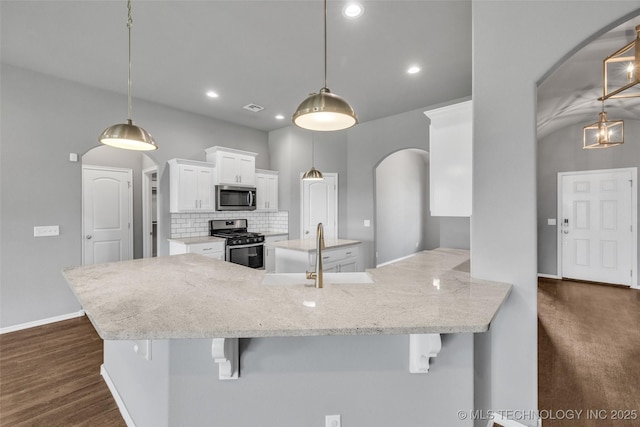 2012 W Huntsville Pl, Broken Arrow, OK 74011 - kitchen featuring appliances with stainless steel finishes, arched walkways, white cabinetry, tasteful backsplash, and light stone counters