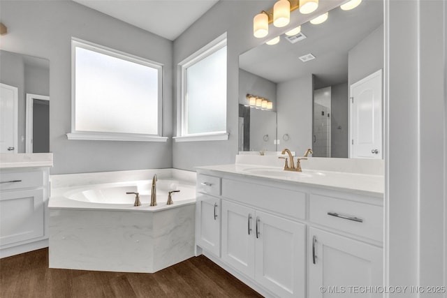 2012 W Huntsville Pl, Broken Arrow, OK 74011 - bathroom with vanity, a garden tub, wood finished floors, and a stall shower
