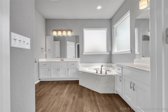 2012 W Huntsville Pl, Broken Arrow, OK 74011 - bathroom with wood finished floors, two vanities, and a bath