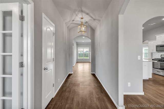2012 W Huntsville Pl, Broken Arrow, OK 74011 - hallway with arched walkways and dark wood finished floors