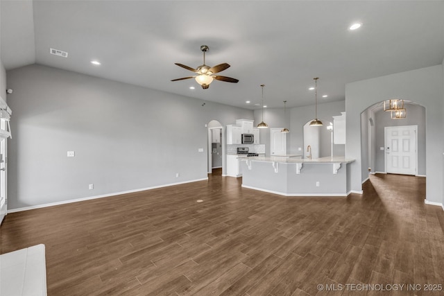 2012 W Huntsville Pl, Broken Arrow, OK 74011 - unfurnished living room with arched walkways, ceiling fan, recessed lighting, and dark wood-type flooring