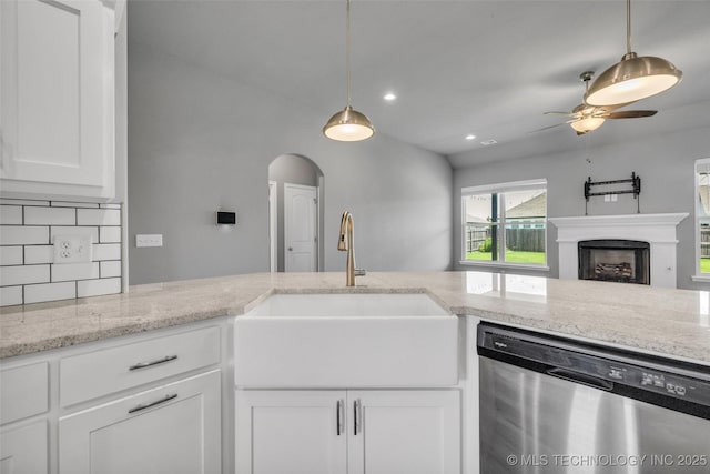 2012 W Huntsville Pl, Broken Arrow, OK 74011 - kitchen with stainless steel dishwasher, a ceiling fan, arched walkways, white cabinets, and recessed lighting