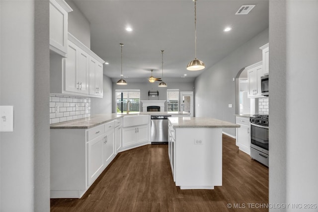 2012 W Huntsville Pl, Broken Arrow, OK 74011 - kitchen featuring appliances with stainless steel finishes, a ceiling fan, tasteful backsplash, recessed lighting, and dark wood-style flooring