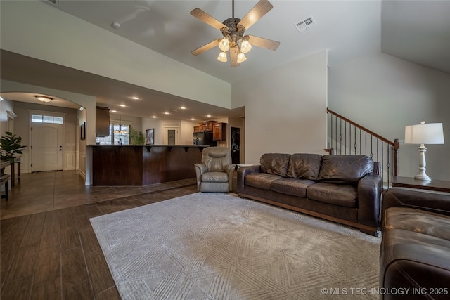 14701 E 150th St, Collinsville, OK 74021 - living area featuring ceiling fan, arched walkways, high vaulted ceiling, dark wood finished floors, and stairway