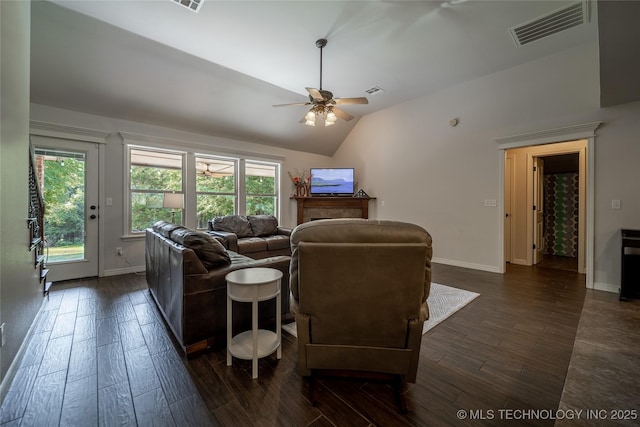 14701 E 150th St, Collinsville, OK 74021 - living room featuring dark wood-type flooring, a ceiling fan, vaulted ceiling, and plenty of natural light