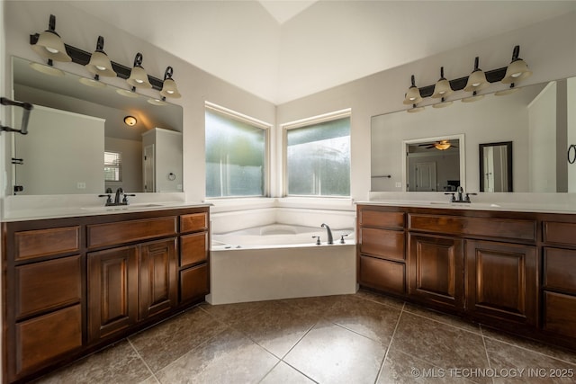 14701 E 150th St, Collinsville, OK 74021 - bathroom featuring two vanities, a garden tub, a ceiling fan, and tile patterned floors