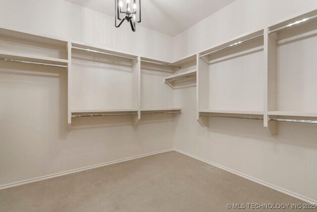 5918 E 126th Pl S, Bixby, OK 74008 - walk in closet with carpet floors and a chandelier