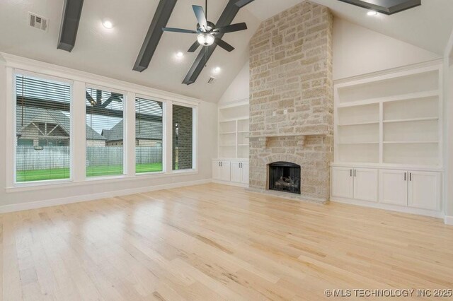 5918 E 126th Pl S, Bixby, OK 74008 - unfurnished living room with built in features, a stone fireplace, wood finished floors, a ceiling fan, and high vaulted ceiling