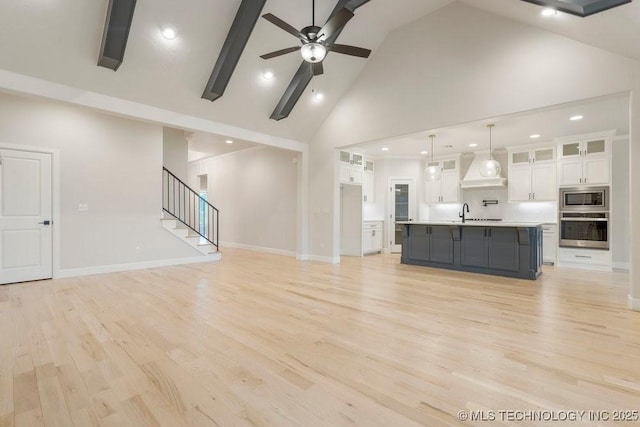 5918 E 126th Pl S, Bixby, OK 74008 - unfurnished living room with high vaulted ceiling, stairs, ceiling fan, light wood-type flooring, and recessed lighting