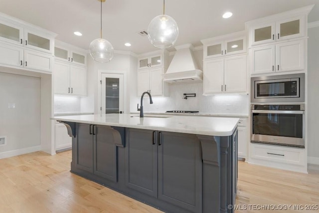5918 E 126th Pl S, Bixby, OK 74008 - kitchen with appliances with stainless steel finishes, custom exhaust hood, light countertops, light wood-style flooring, and recessed lighting