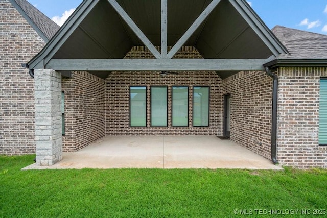 5918 E 126th Pl S, Bixby, OK 74008 - back of house featuring brick siding, a patio, a yard, and a shingled roof