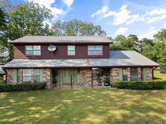 311 Washington Ave, Boswell, OK 74727 - view of front facade with brick siding, a front yard, and a metal roof