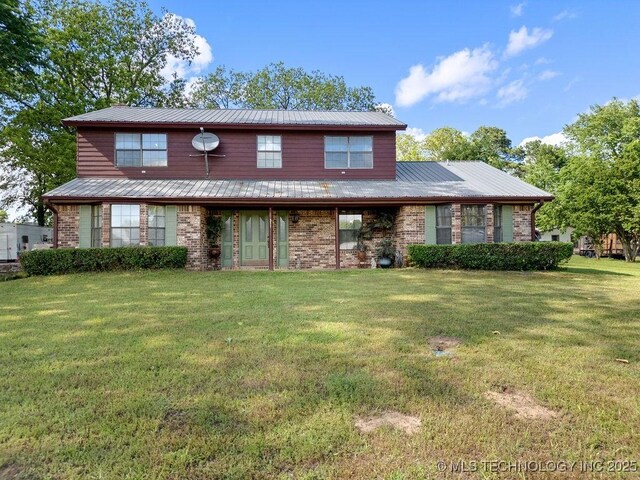 311 Washington Ave, Boswell, OK 74727 - traditional home with a front yard, brick siding, and a metal roof