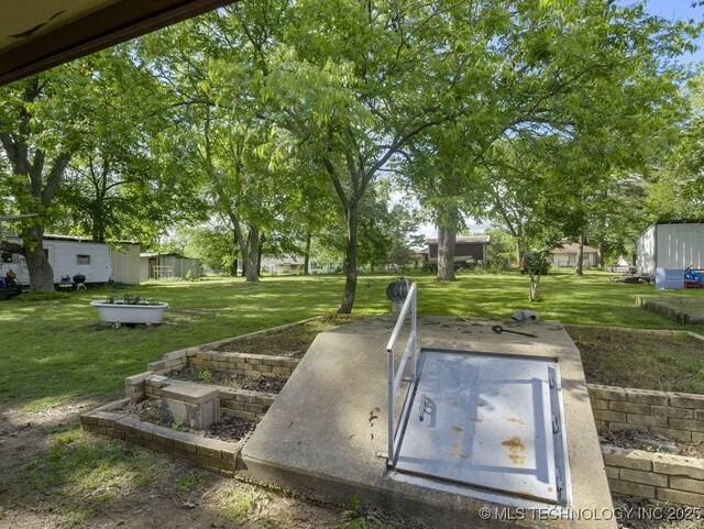 311 Washington Ave, Boswell, OK 74727 - entry to storm shelter featuring a lawn