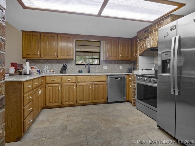 311 Washington Ave, Boswell, OK 74727 - kitchen featuring appliances with stainless steel finishes, decorative backsplash, light countertops, light stone finish flooring, and brown cabinetry