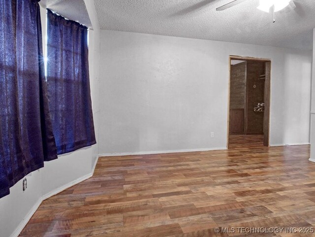 311 Washington Ave, Boswell, OK 74727 - empty room featuring wood finished floors, a ceiling fan, and a textured ceiling
