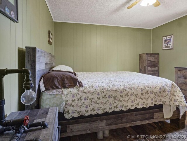 311 Washington Ave, Boswell, OK 74727 - bedroom featuring wood finished floors, a textured ceiling, ornamental molding, and ceiling fan