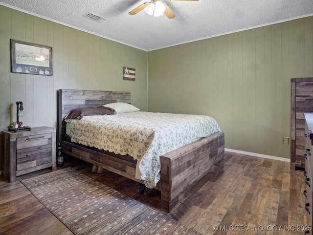 311 Washington Ave, Boswell, OK 74727 - bedroom featuring wood finished floors, a textured ceiling, ornamental molding, and a ceiling fan