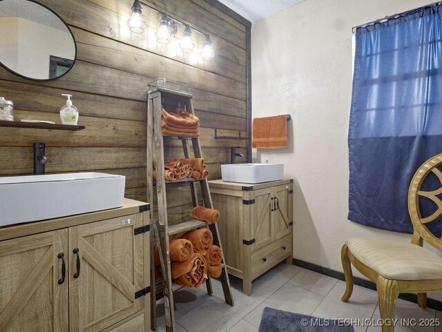 311 Washington Ave, Boswell, OK 74727 - bathroom with wooden walls, tile patterned floors, and vanity
