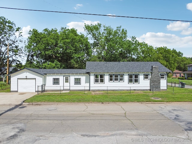 1119 W 7th St, Okmulgee, OK 74447 - view of front of house with a fenced front yard, an attached garage, and concrete driveway