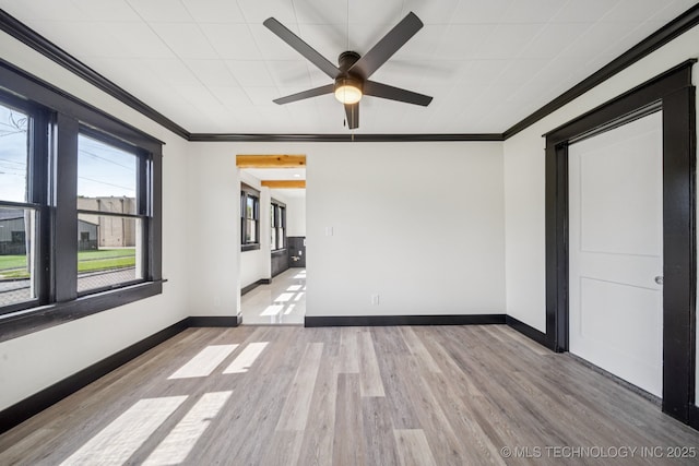 1119 W 7th St, Okmulgee, OK 74447 - unfurnished room with crown molding, a ceiling fan, and light wood-style flooring