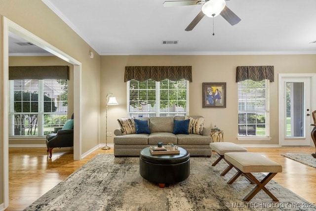 8306 E 77th Pl, Tulsa, OK 74133 - living room featuring crown molding, wood finished floors, and a ceiling fan