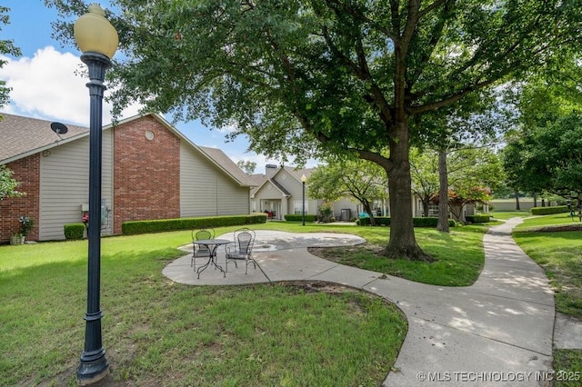 8306 E 77th Pl, Tulsa, OK 74133 - view of grassy yard with a patio area