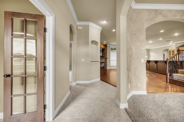 14651 S Gary Ave, Bixby, OK 74008 - foyer with arched walkways, stairway, ornamental molding, a glass covered fireplace, and recessed lighting
