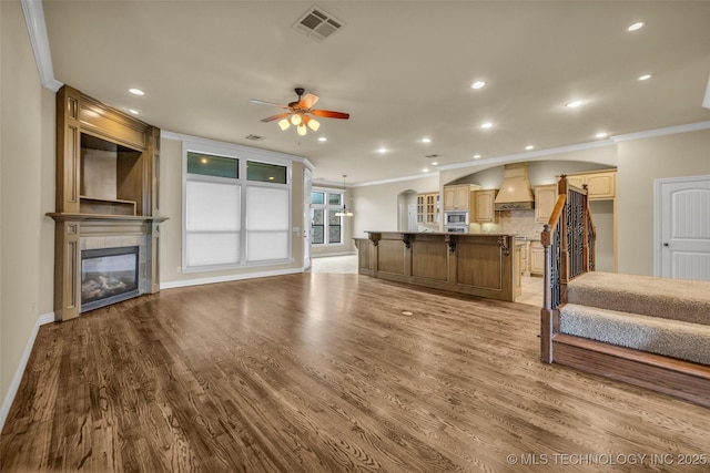 14651 S Gary Ave, Bixby, OK 74008 - living room with ornamental molding, a ceiling fan, wood finished floors, a fireplace, and recessed lighting