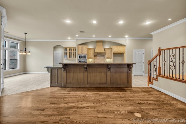 14651 S Gary Ave, Bixby, OK 74008 - kitchen featuring custom range hood, stainless steel appliances, a chandelier, crown molding, and light tile patterned floors
