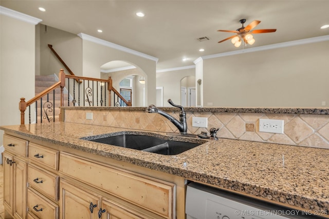 14651 S Gary Ave, Bixby, OK 74008 - kitchen featuring arched walkways, backsplash, crown molding, light brown cabinetry, and light stone counters