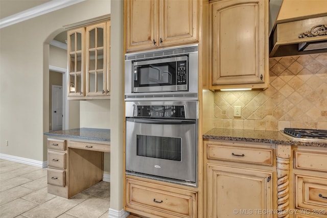 14651 S Gary Ave, Bixby, OK 74008 - kitchen featuring stainless steel appliances, premium range hood, light brown cabinetry, tasteful backsplash, and dark stone countertops