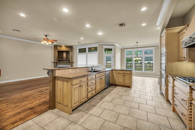 14651 S Gary Ave, Bixby, OK 74008 - kitchen with ornamental molding, a ceiling fan, recessed lighting, stainless steel appliances, and a kitchen island with sink