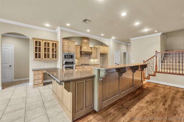 14651 S Gary Ave, Bixby, OK 74008 - kitchen with stainless steel appliances, premium range hood, a large island, glass insert cabinets, and recessed lighting