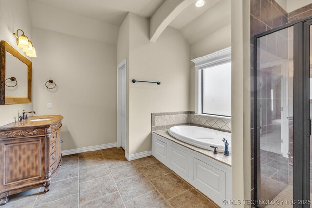 14651 S Gary Ave, Bixby, OK 74008 - full bathroom with vanity, a garden tub, a stall shower, and lofted ceiling