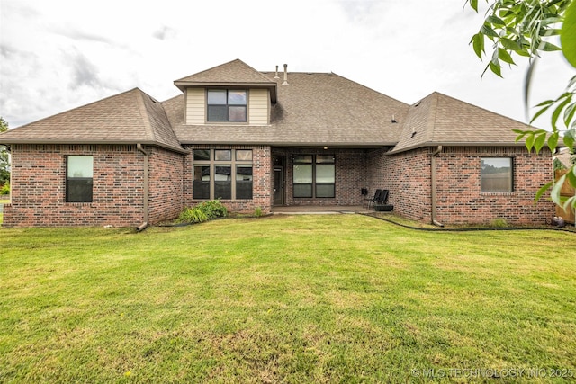 14651 S Gary Ave, Bixby, OK 74008 - back of property with brick siding, roof with shingles, a patio area, and a lawn