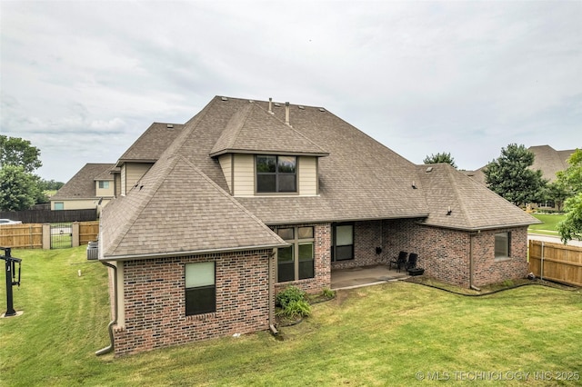 14651 S Gary Ave, Bixby, OK 74008 - back of property with brick siding, a patio area, a shingled roof, and a fenced backyard