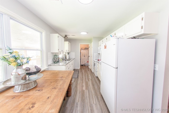 1119 N Oklahoma Ave, Claremore, OK 74017 - kitchen featuring white appliances, white cabinetry, light wood-style floors, and backsplash