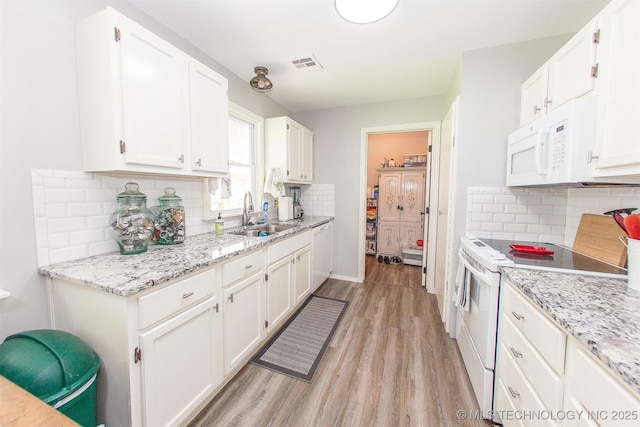1119 N Oklahoma Ave, Claremore, OK 74017 - kitchen with white appliances, light wood-style floors, white cabinetry, tasteful backsplash, and light stone counters
