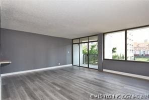 410 W 7th St Unit 224, Tulsa, OK 74119 - empty room featuring baseboards and wood finished floors