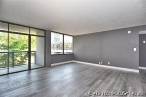 410 W 7th St Unit 224, Tulsa, OK 74119 - empty room featuring wood finished floors and expansive windows