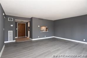 410 W 7th St Unit 224, Tulsa, OK 74119 - unfurnished living room with wood finished floors and baseboards
