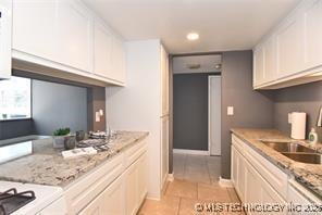 410 W 7th St Unit 224, Tulsa, OK 74119 - kitchen with white cabinetry, light tile patterned flooring, and recessed lighting