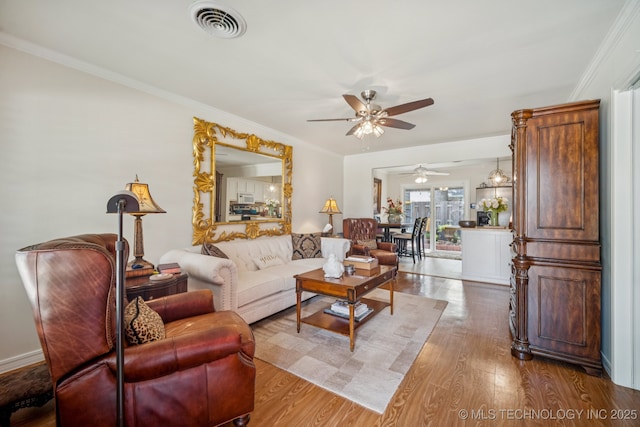 5612 S Newport Ave Unit 5612, Tulsa, OK 74105 - living room with a ceiling fan, wood finished floors, and ornamental molding