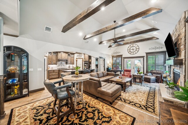 3818 W Phoenix Pl, Broken Arrow, OK 74011 - living room featuring beam ceiling, ceiling fan, light wood-style flooring, high vaulted ceiling, and a fireplace