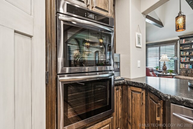 3818 W Phoenix Pl, Broken Arrow, OK 74011 - kitchen featuring stainless steel double oven, dark stone countertops, and pendant lighting