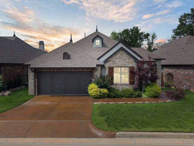 3818 W Phoenix Pl, Broken Arrow, OK 74011 - french provincial home with stone siding, an attached garage, concrete driveway, and a front lawn