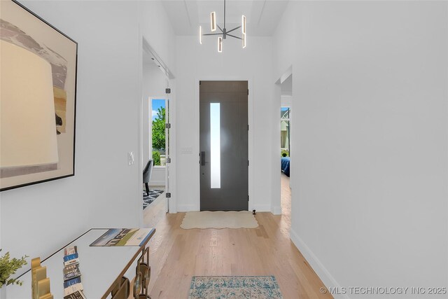 12005 S Vandalia Ave, Tulsa, OK 74137 - foyer entrance with light wood-type flooring and a chandelier