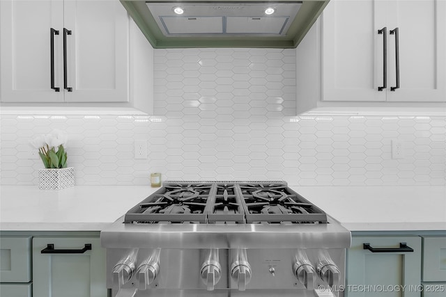 12005 S Vandalia Ave, Tulsa, OK 74137 - kitchen with ventilation hood, light countertops, decorative backsplash, and white cabinetry