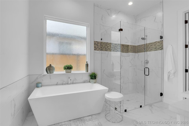 12005 S Vandalia Ave, Tulsa, OK 74137 - bathroom with a soaking tub, plenty of natural light, a marble finish shower, marble finish flooring, and tile walls